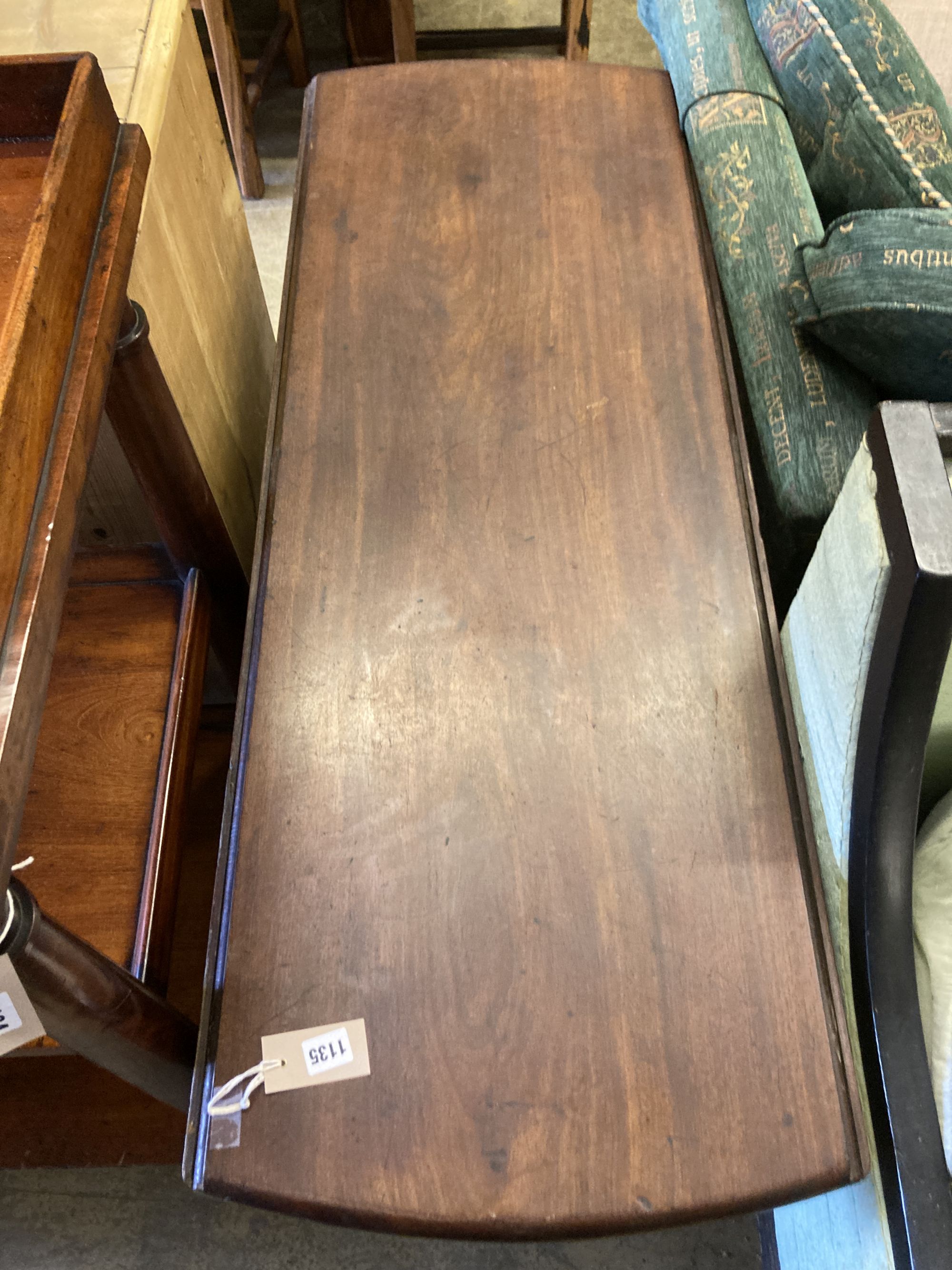 A George III oval mahogany drop leaf pad foot dining table, 142cm extended, width 122cm, height 71cm (in need of restoration)